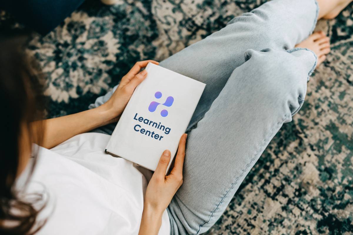 Person holding a Hemmat Law Group Learning Center booklet | Hemmat Law Group